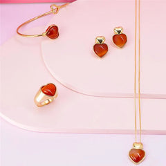 ANEL CORAÇÃO DOURADO PEDRA CABOCHÃO LISO