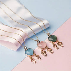 PINGENTE DUAS MENINAS FILHOS PEDRA CABOCHÃO CORAÇÃO 12X13mm