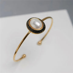 PULSEIRA PÉROLAS DOURADO COM RODIO NEGRO OVAL